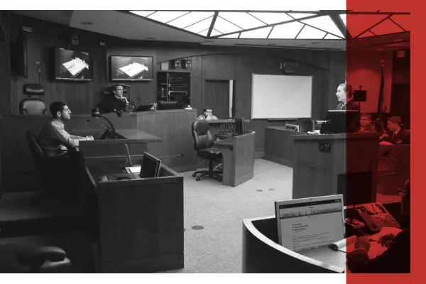 Black and white image of a proceeding taking place in a courtroom