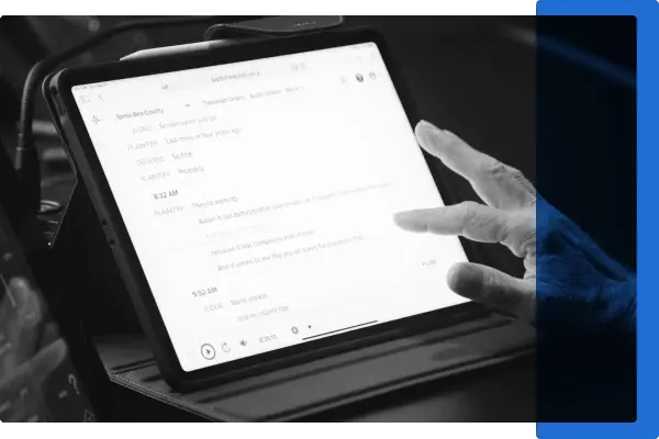 A black and white image of a hand scrolling through a speech-to-text feed